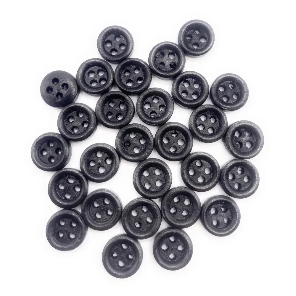 Pile of black four-hole buttons.