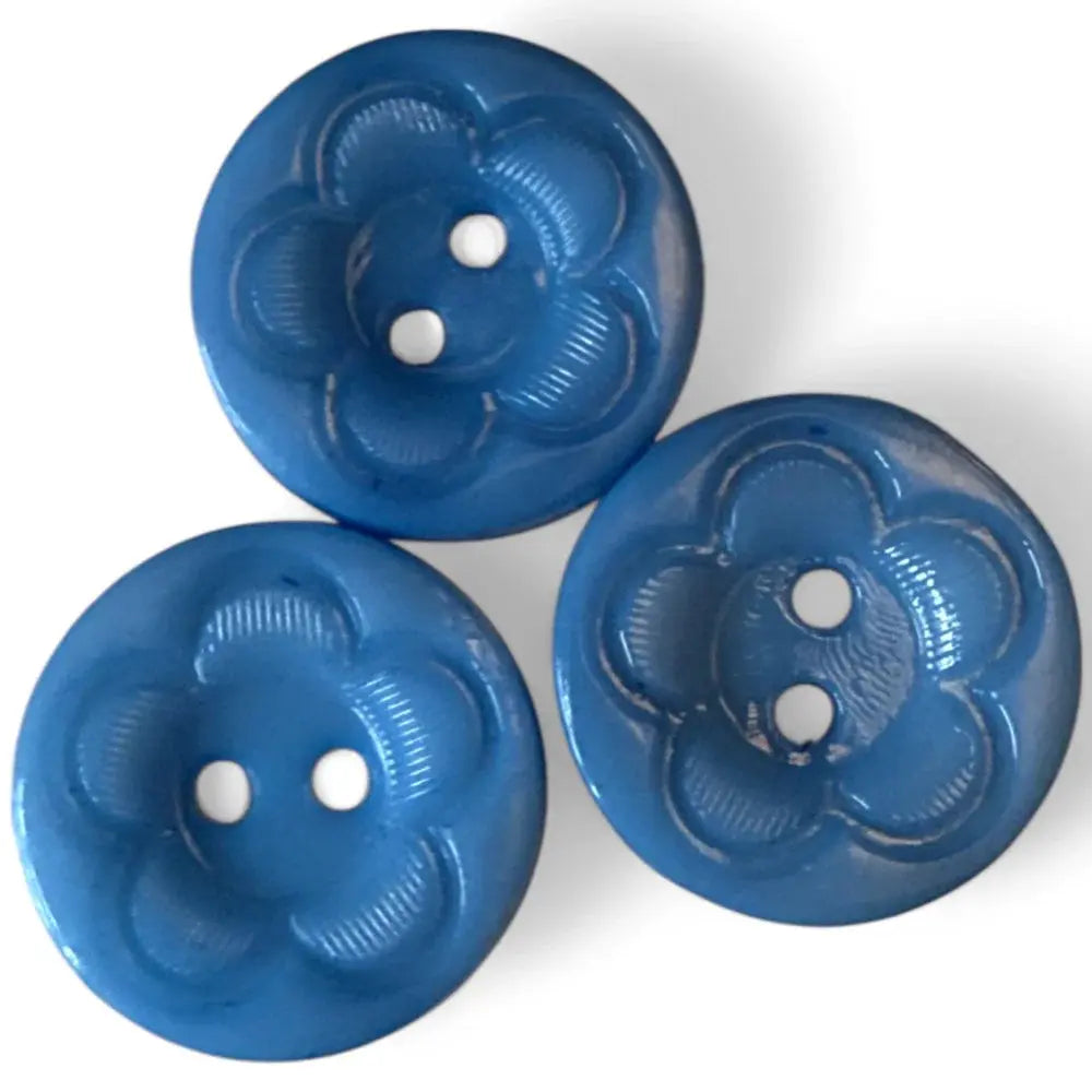 Three blue flower-shaped buttons.