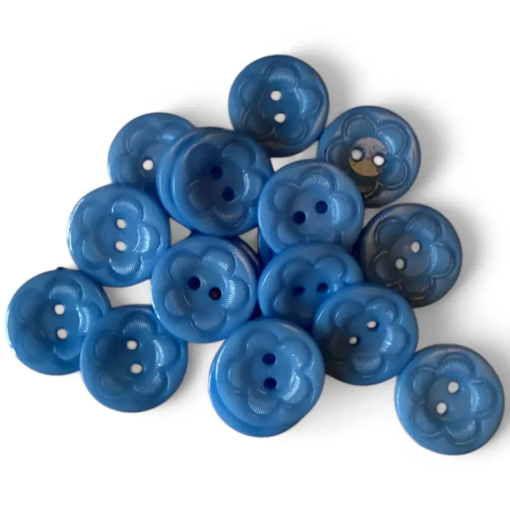 Pile of blue flower-shaped buttons.