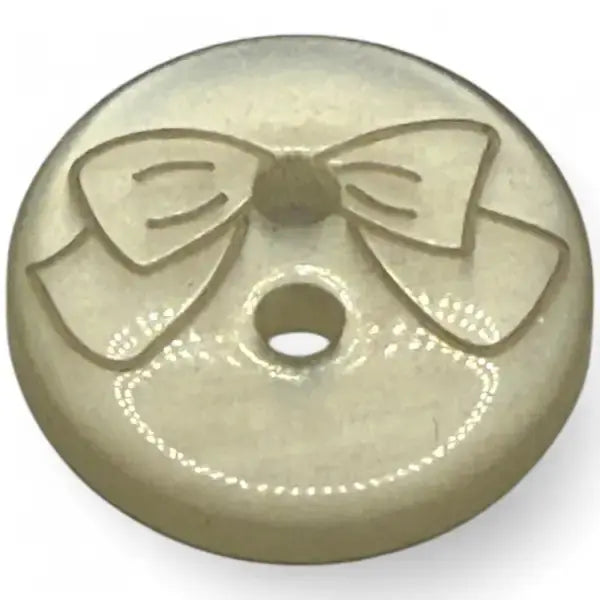 Round button with a bow design.