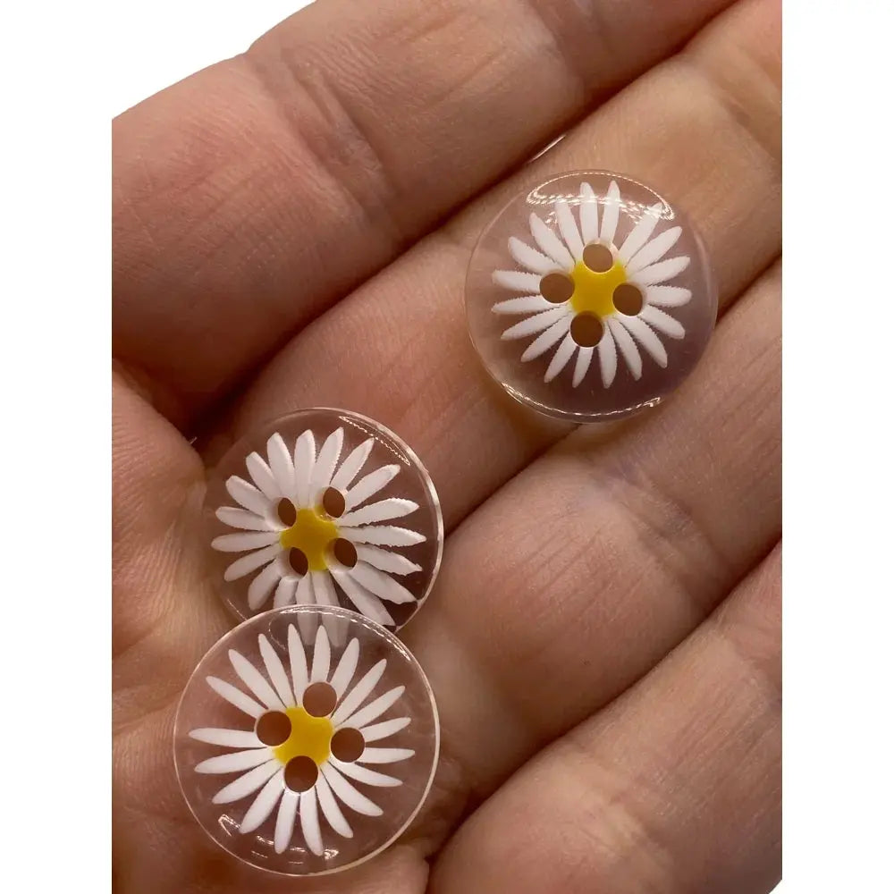 Three daisy-patterned clear buttons.