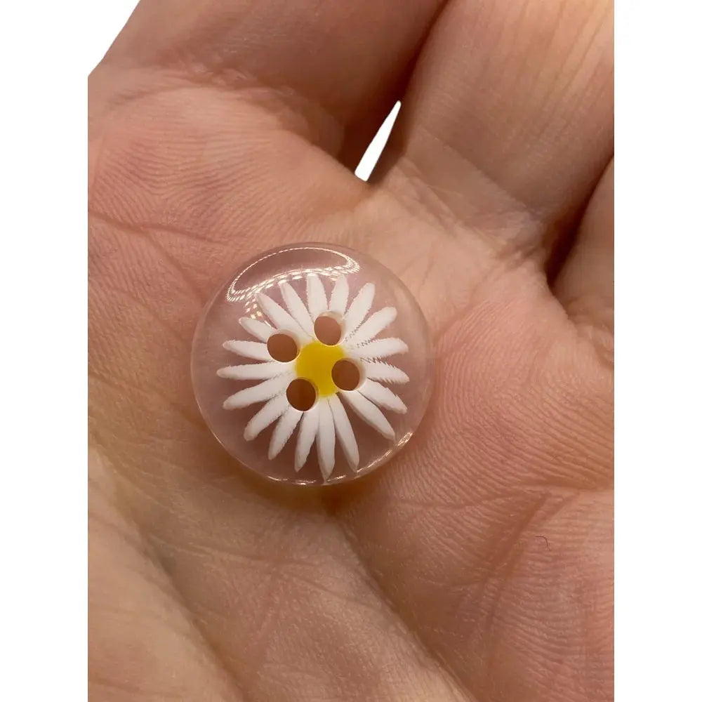 Clear button with daisy design.