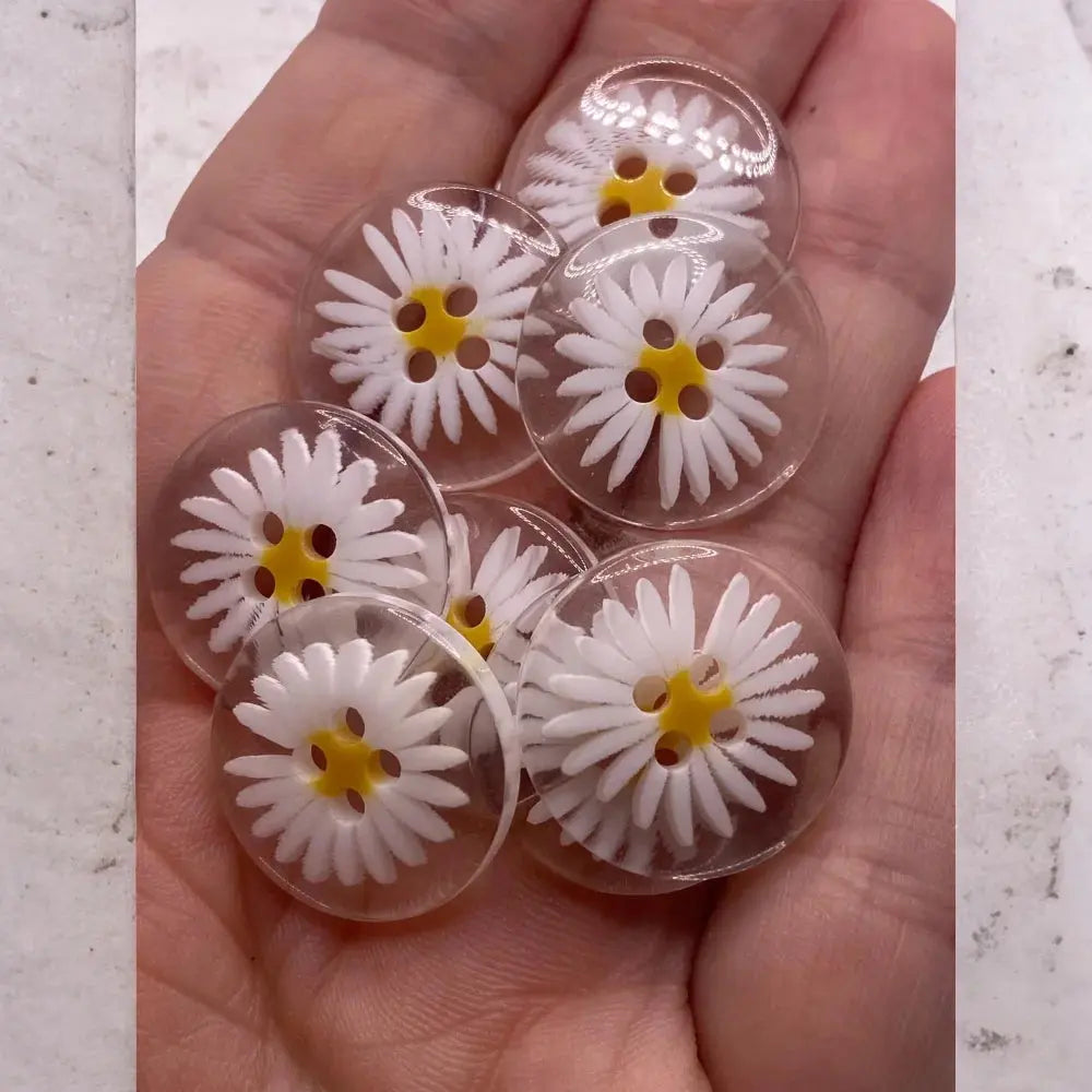 Daisy-themed clear plastic buttons.