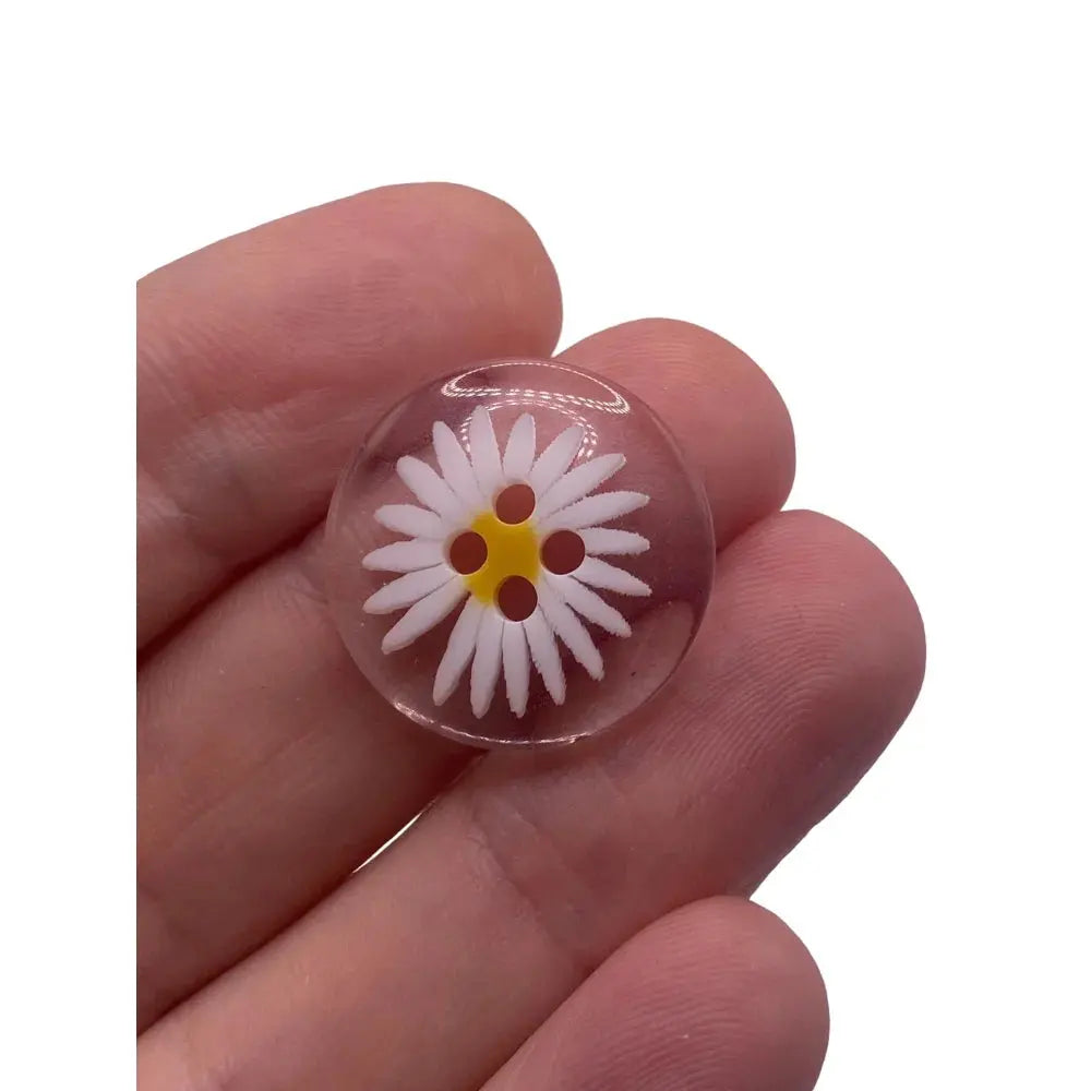 Clear button with daisy design.