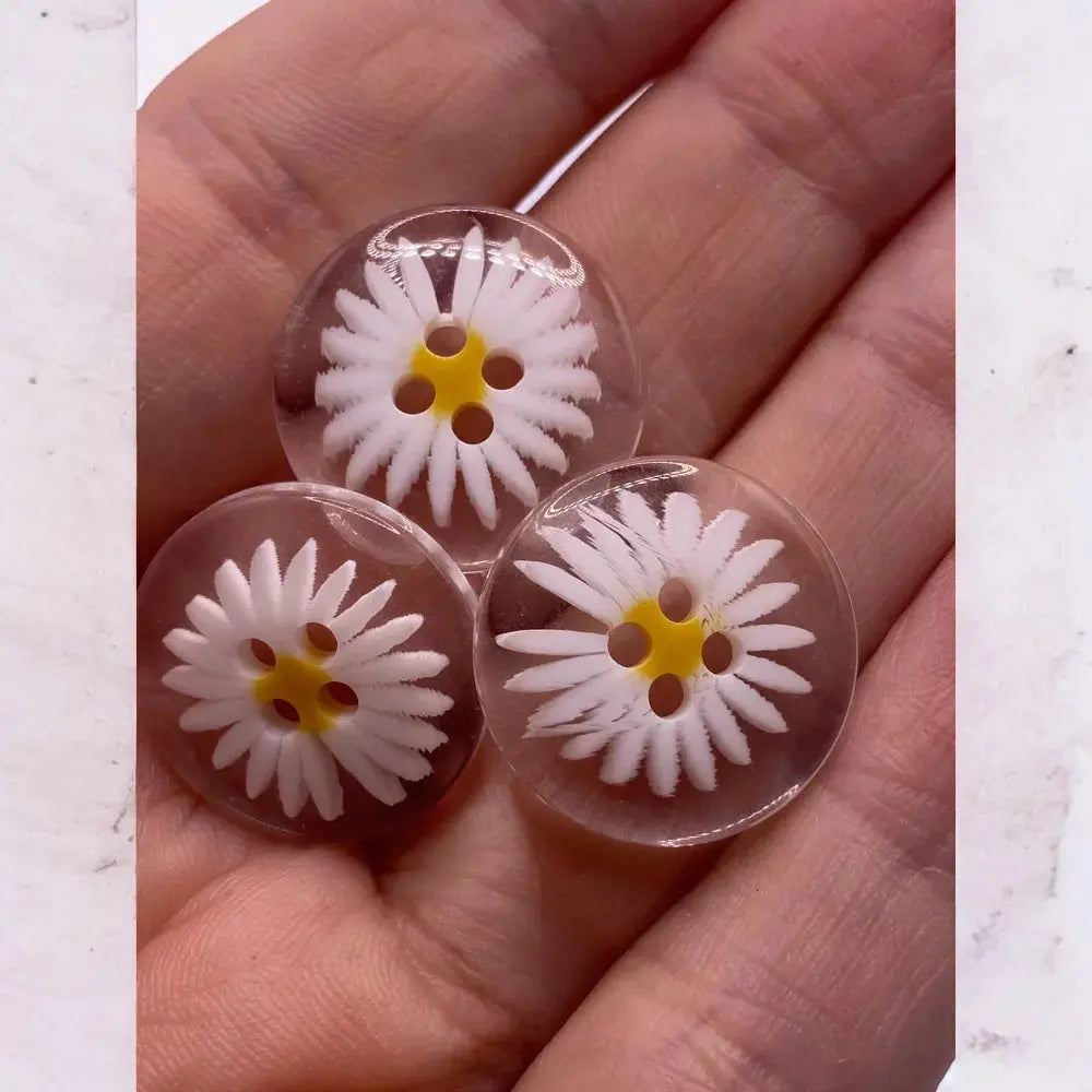 Three clear daisy buttons.