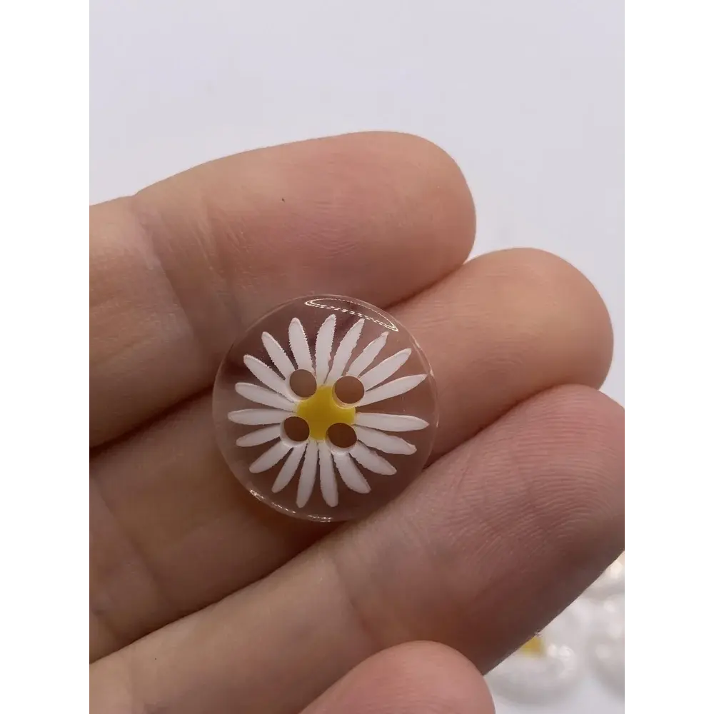Daisy-patterned clear button.