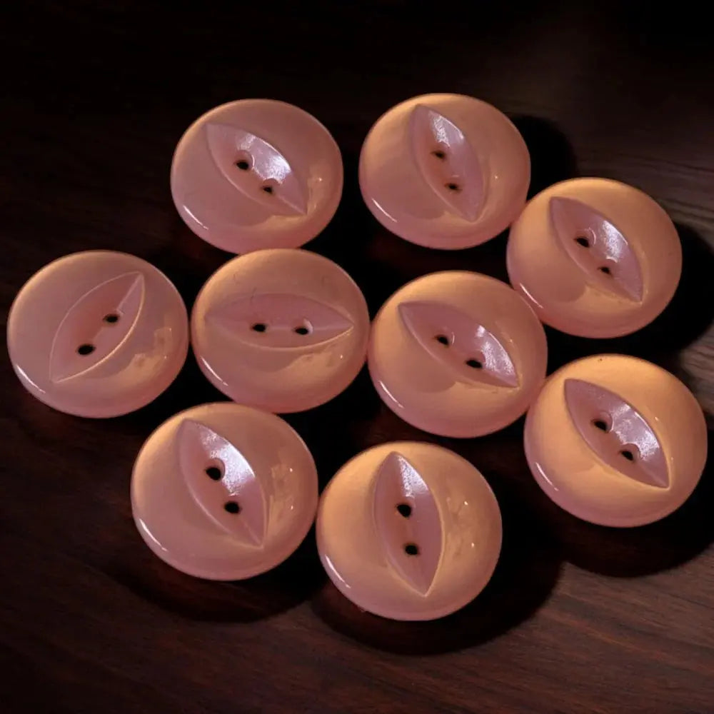 Peach-colored, two-hole buttons.