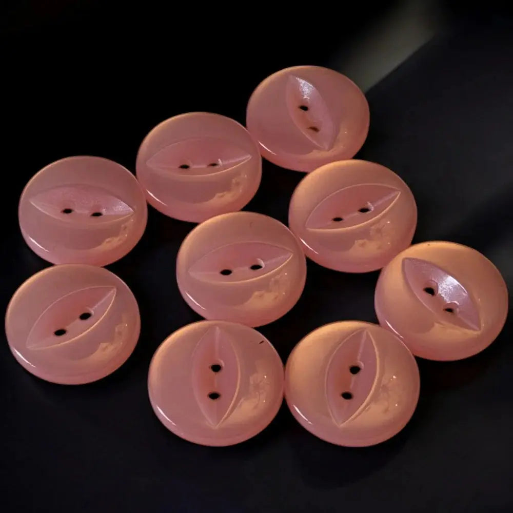 Pink, two-hole, domed buttons.