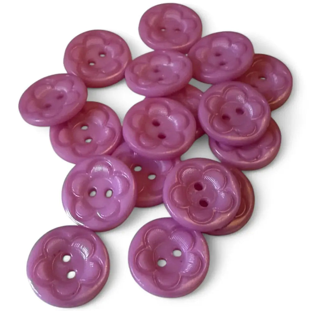 Pile of purple flower-shaped buttons.