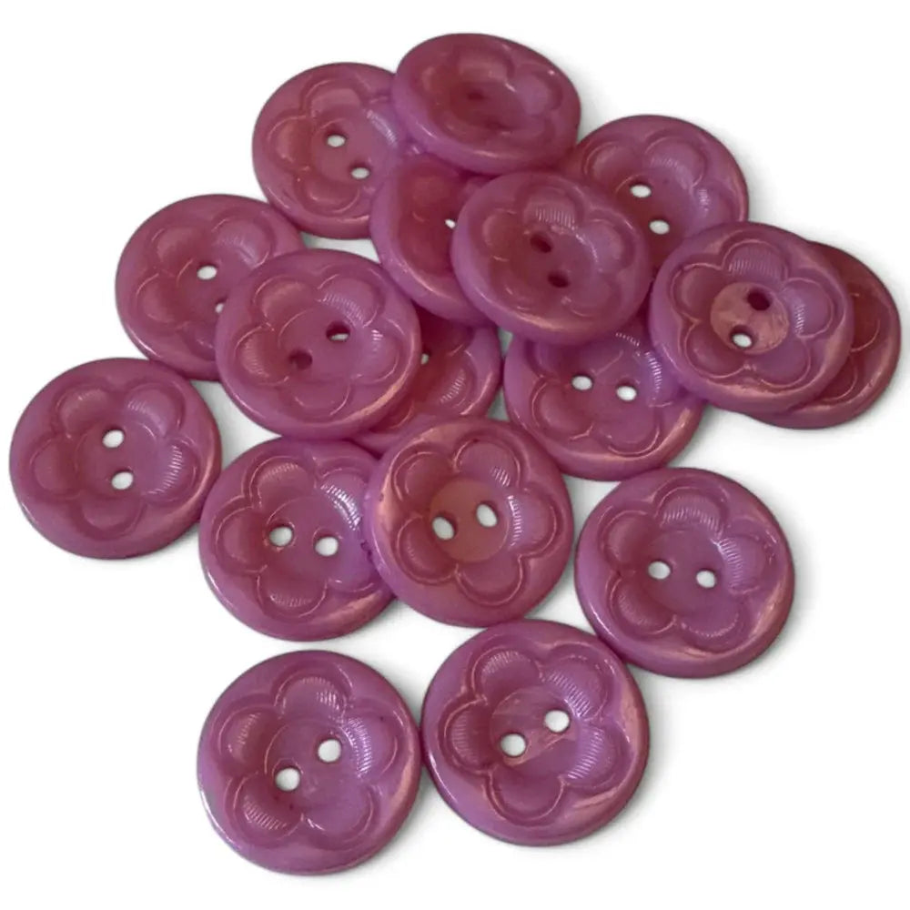 Pile of flower-shaped purple buttons.