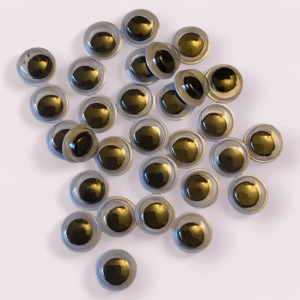 Round, gold-colored craft eyes.
