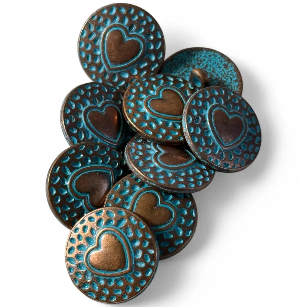 Pile of heart-stamped, turquoise-accented buttons.