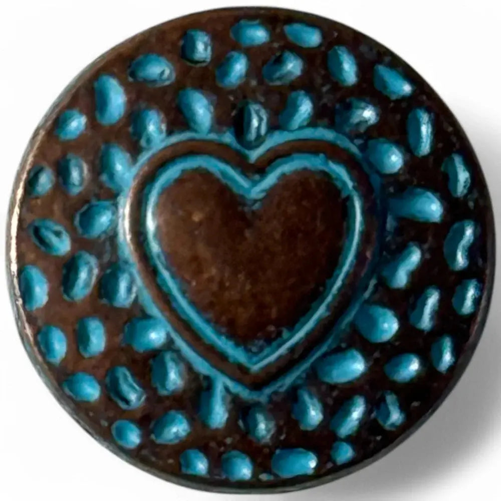 Circular brown button with a blue heart and raised blue dots.