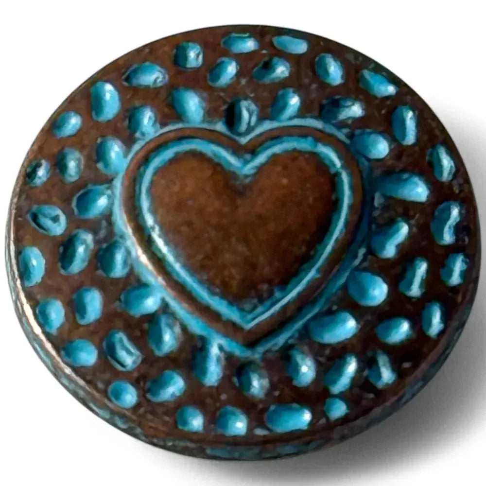 Circular button with a heart design.