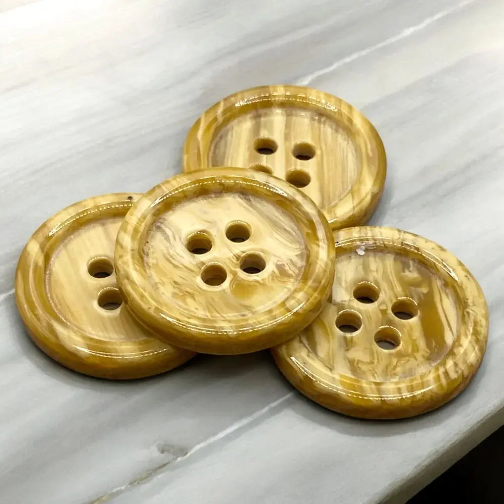 Four-hole, marbled, tan buttons.