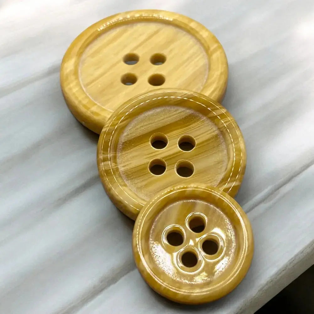 Three wooden four-hole buttons.