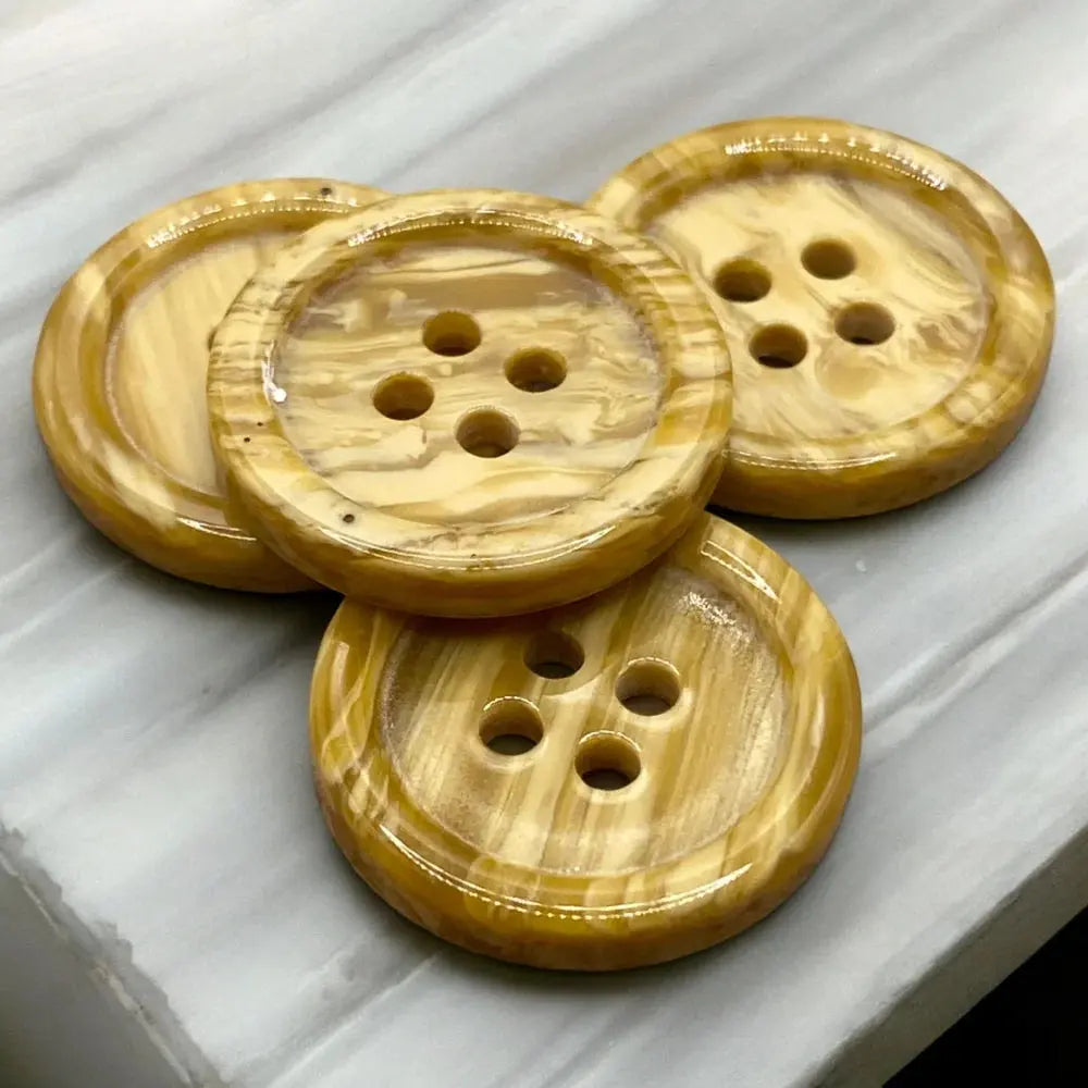 Four-hole, tan-swirled buttons.