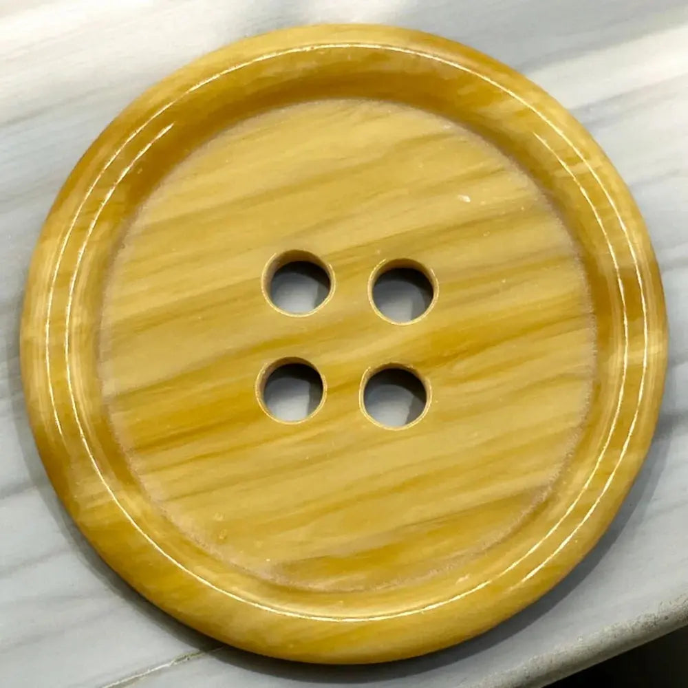 Yellow, four-hole button.