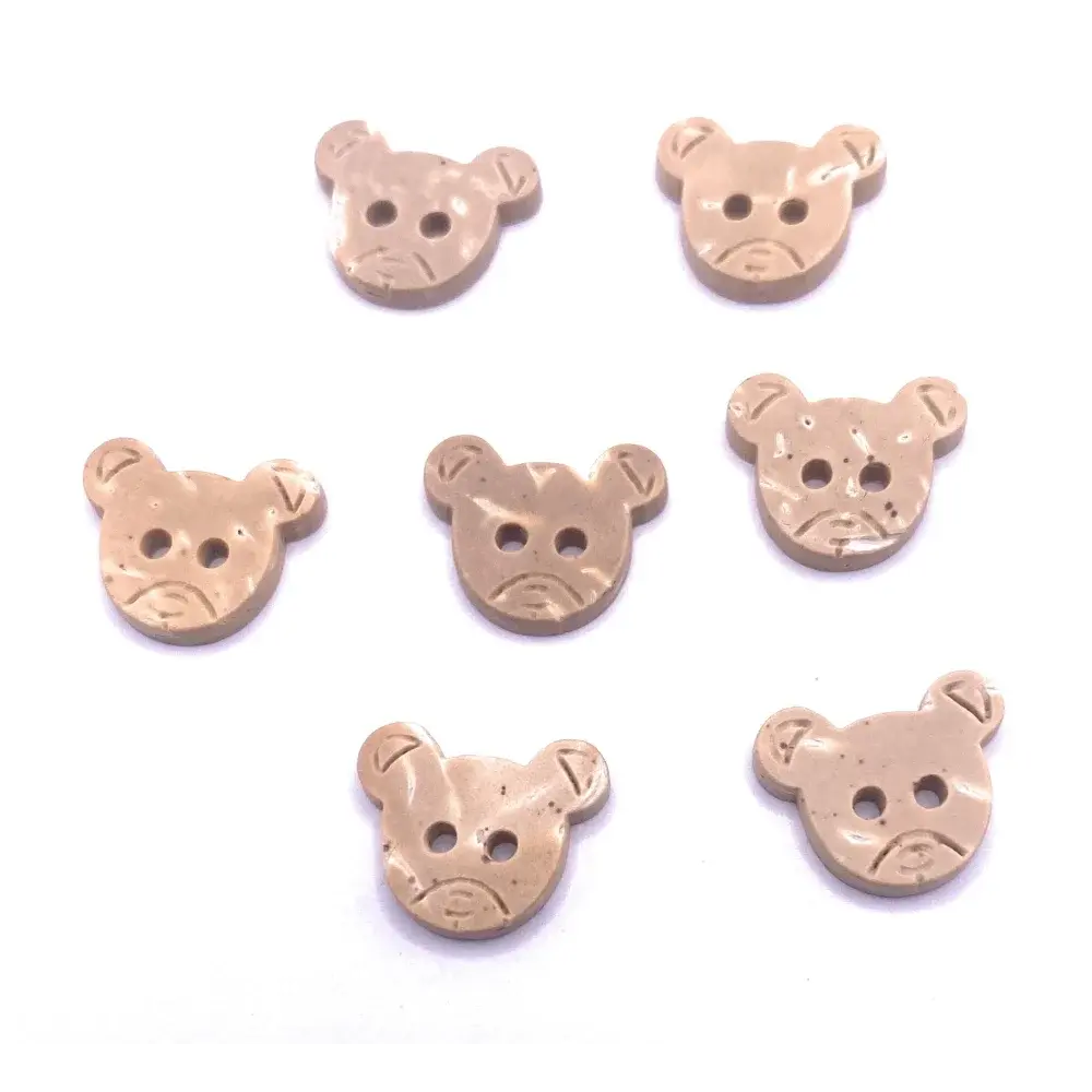 Seven beige bear-shaped buttons.