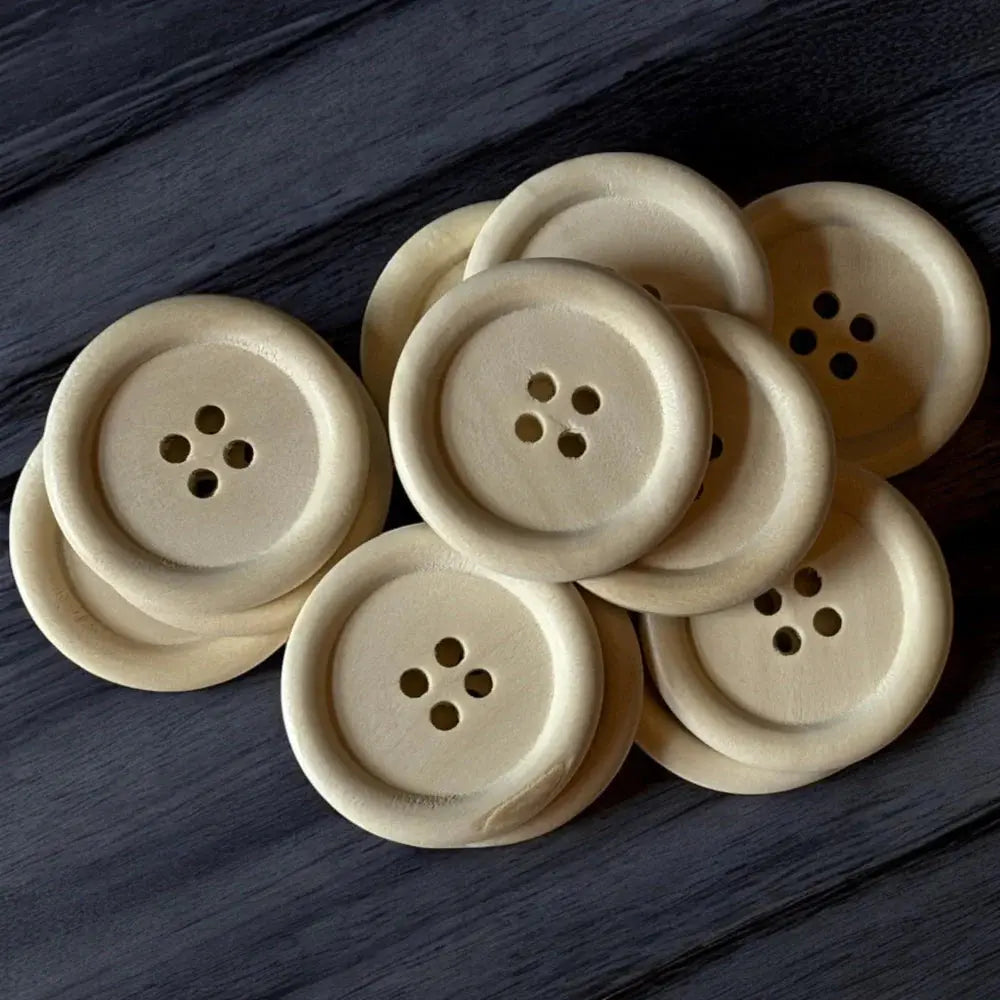 Pile of four-hole wooden buttons.