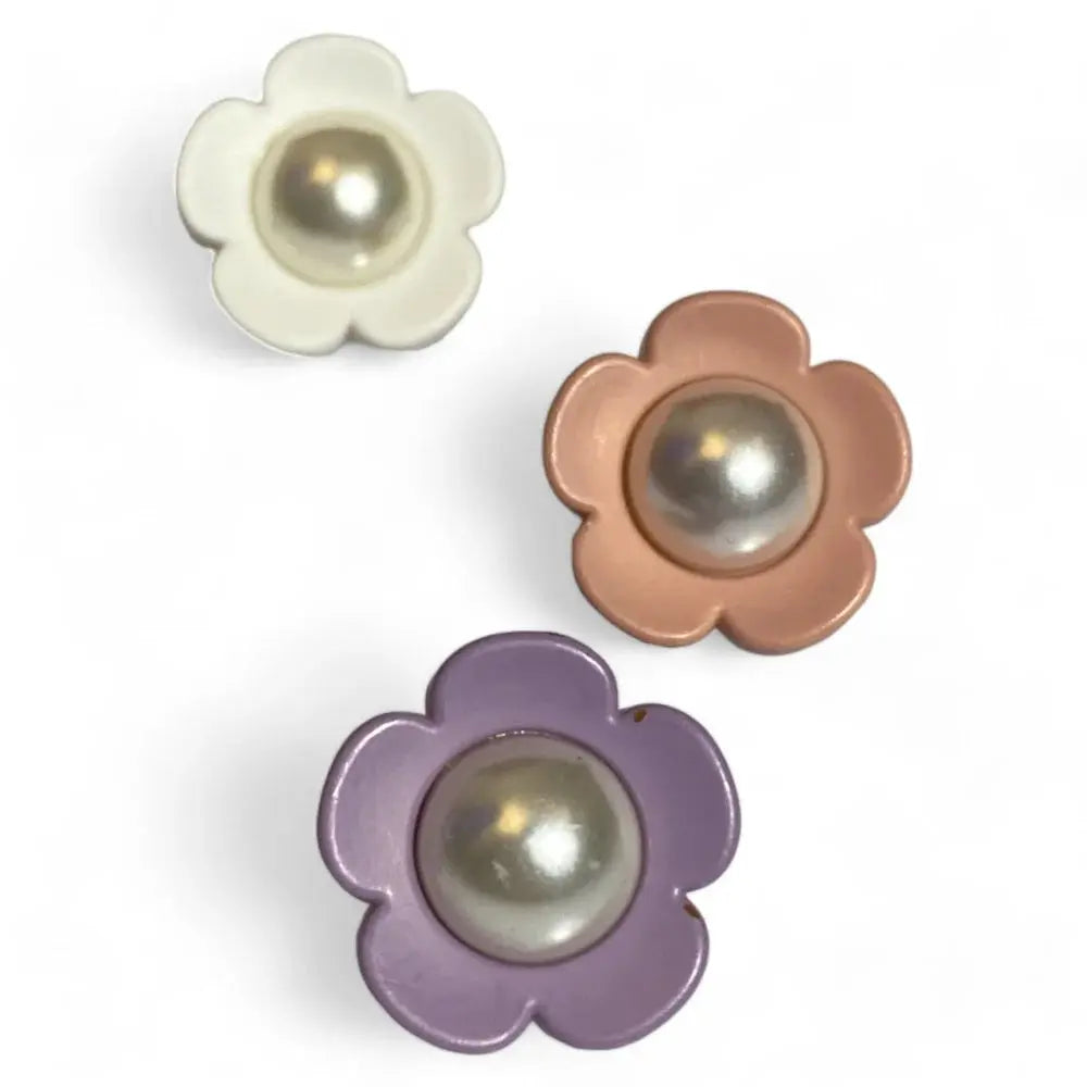 Three flower-shaped buttons with pearl centers.