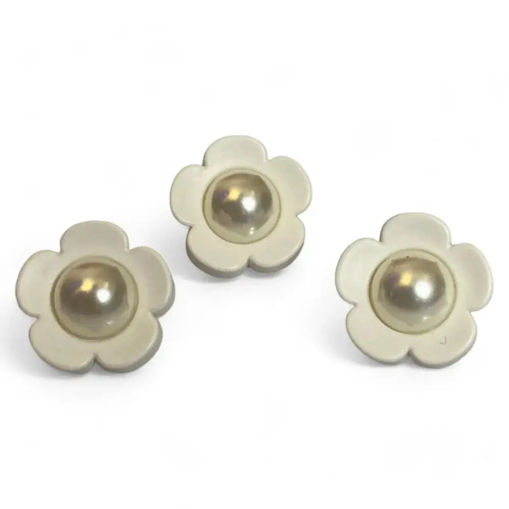 Three flower-shaped pearl buttons.