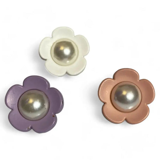 Three flower-shaped buttons with pearl centers.