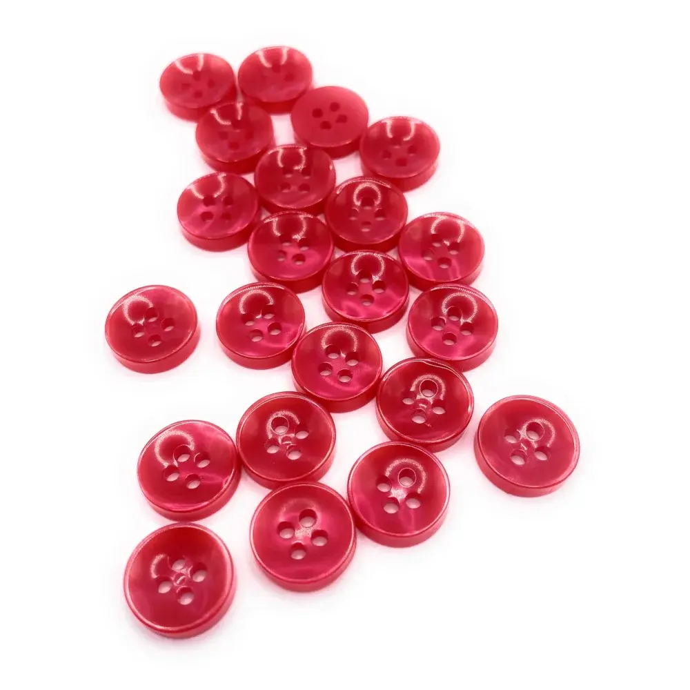 Pile of red plastic buttons.