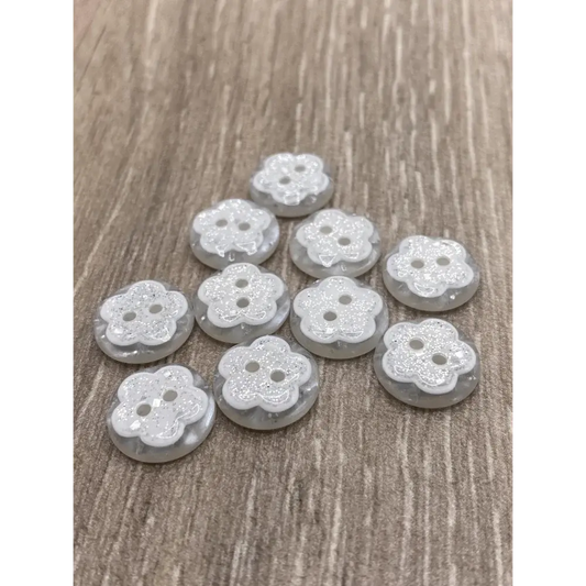 Flower-shaped, glittery, two-hole buttons.