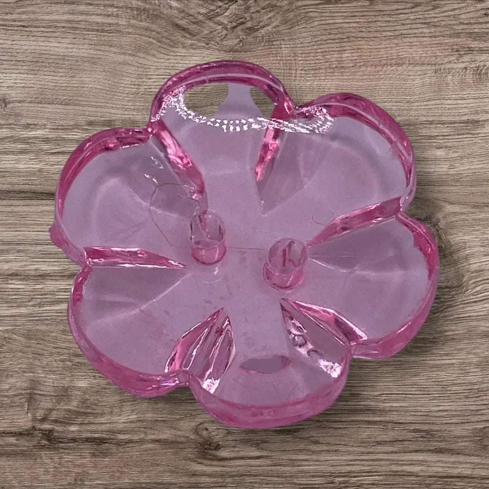 Pink glass flower-shaped dish.