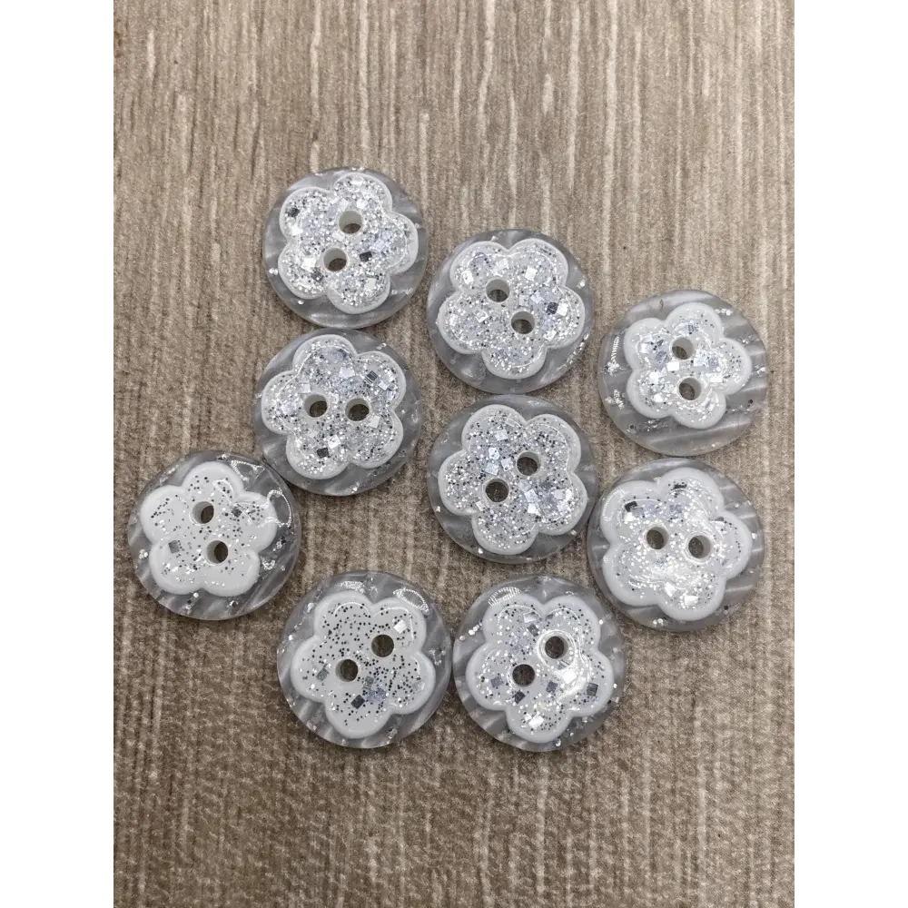 Group of flower-shaped, glittery buttons.