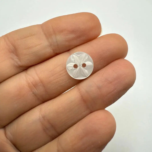 White flower-patterned button.