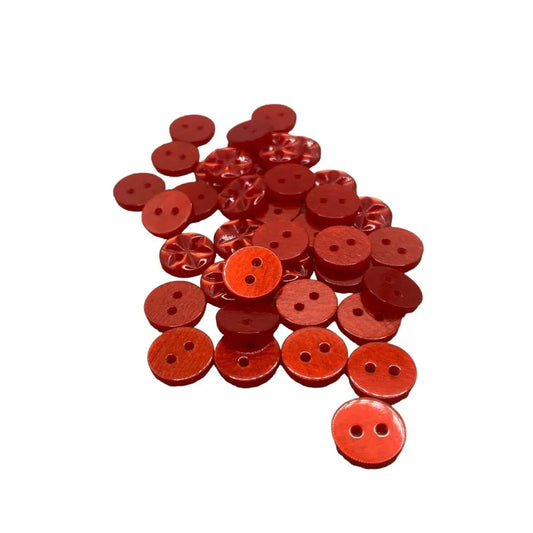 Pile of red, two-hole buttons.