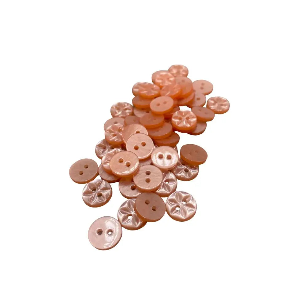 Pile of peach-colored buttons.