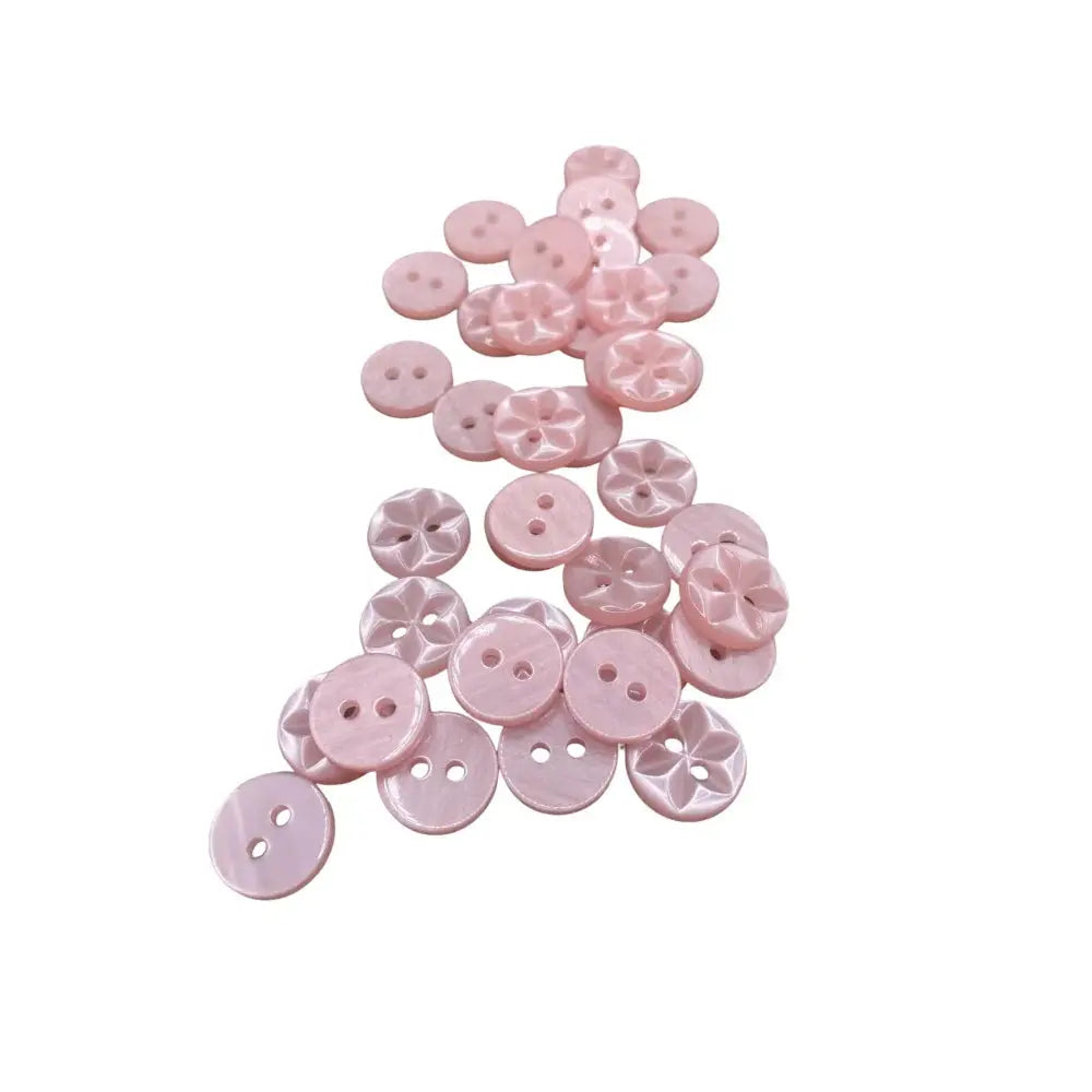 Pile of pink sewing buttons.