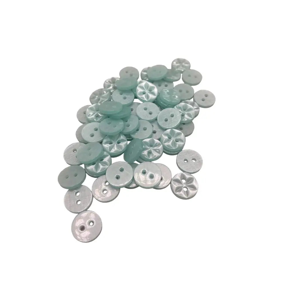 Pile of light blue buttons.