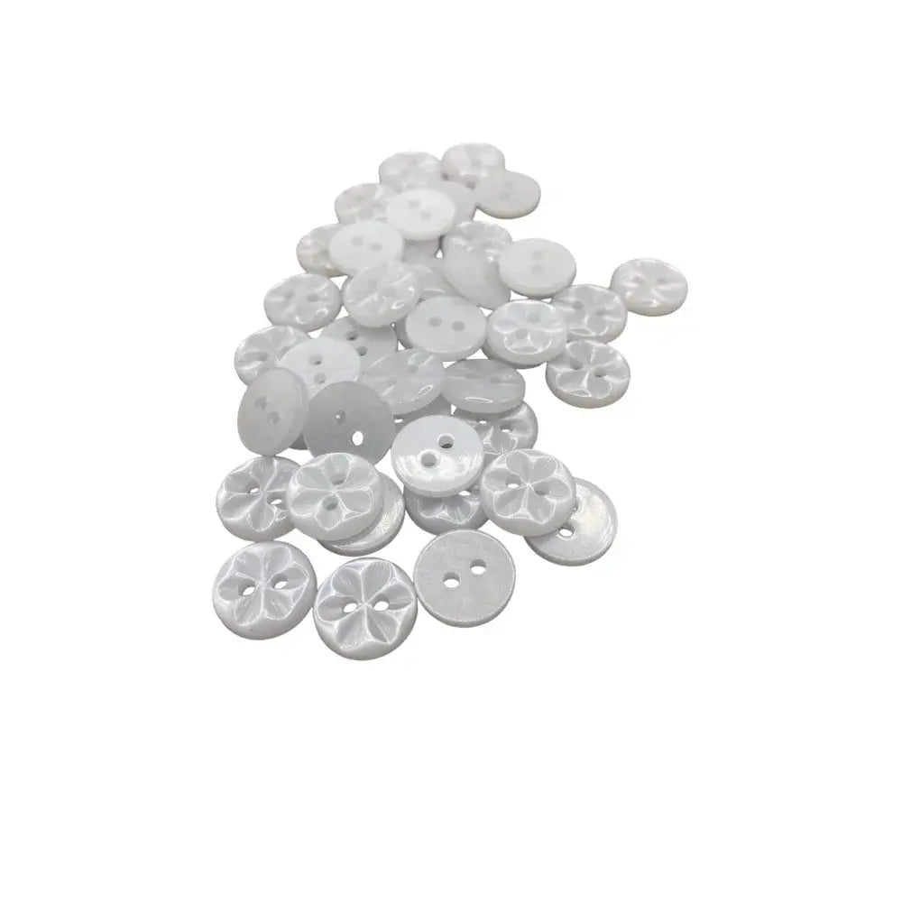 Pile of white, round buttons.