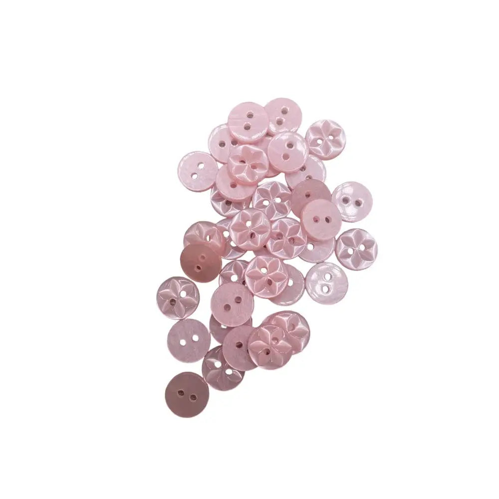 Pile of pink sewing buttons.