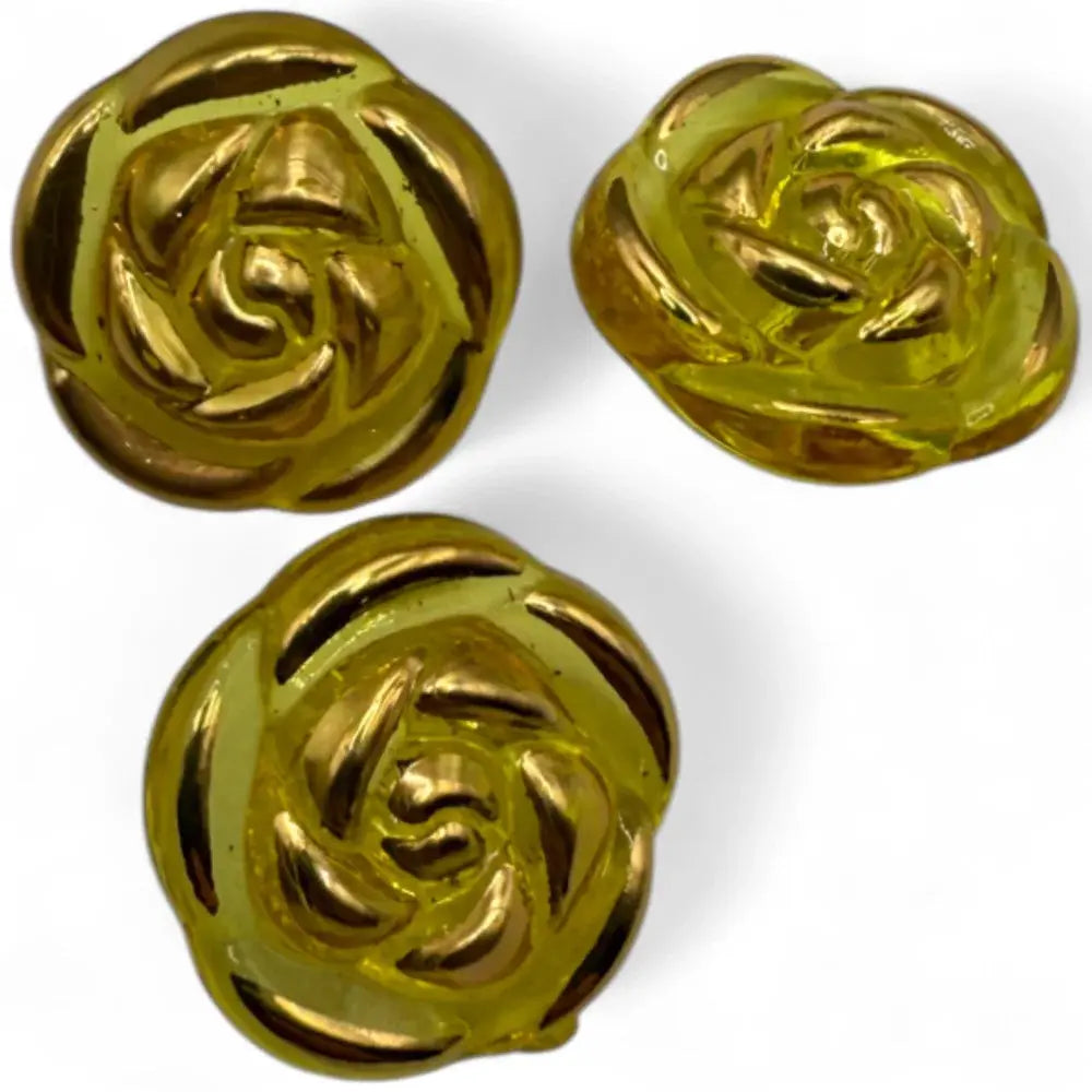 Three golden rose-shaped buttons.