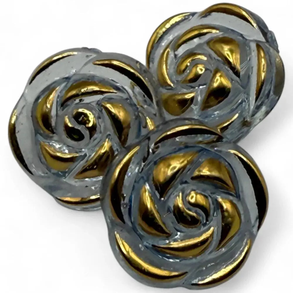 Three glass rose buttons with gold accents.