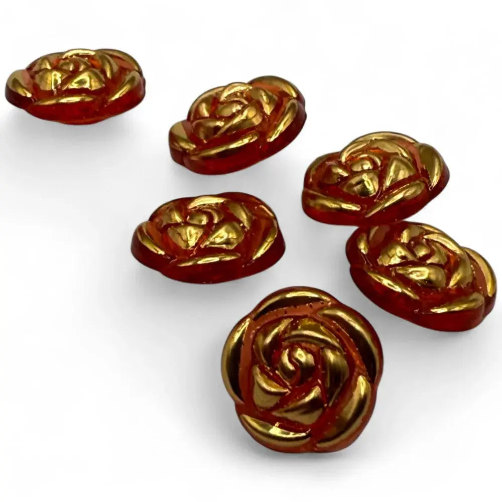 Six rose-shaped, red and gold buttons.