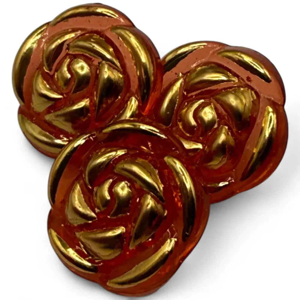 Three rose-shaped, gold-accented buttons.