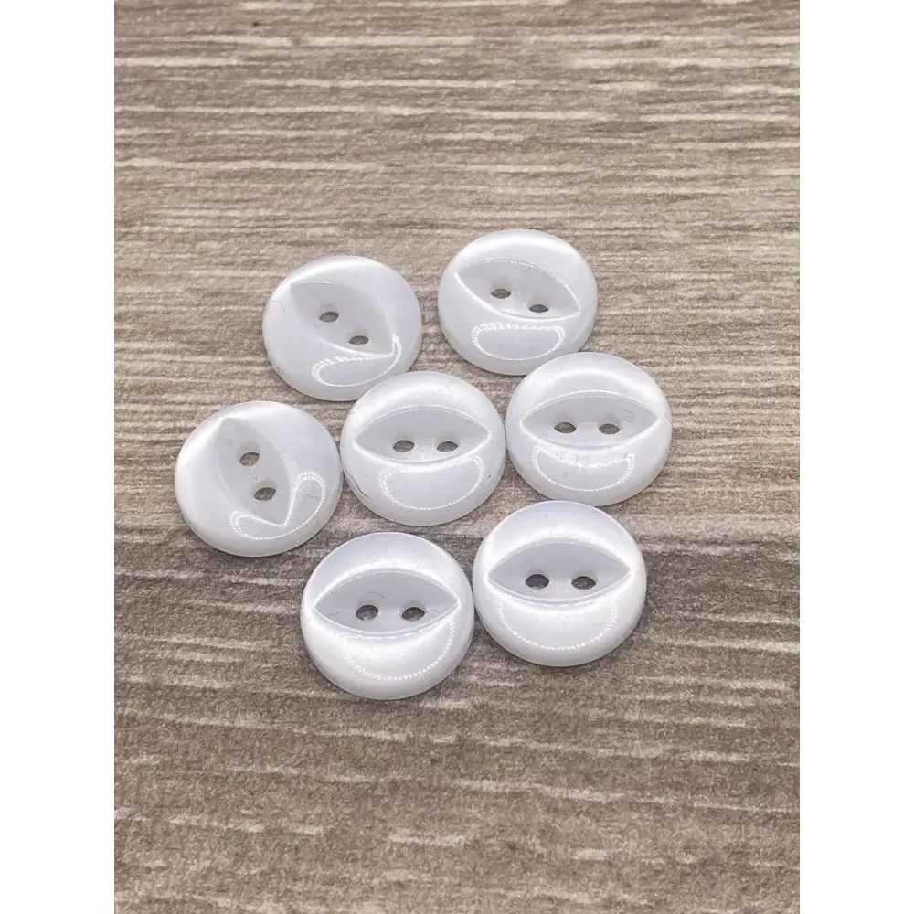 Seven white, two-hole buttons.