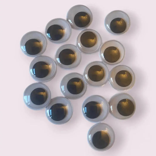 Pile of gray and black googly eyes.