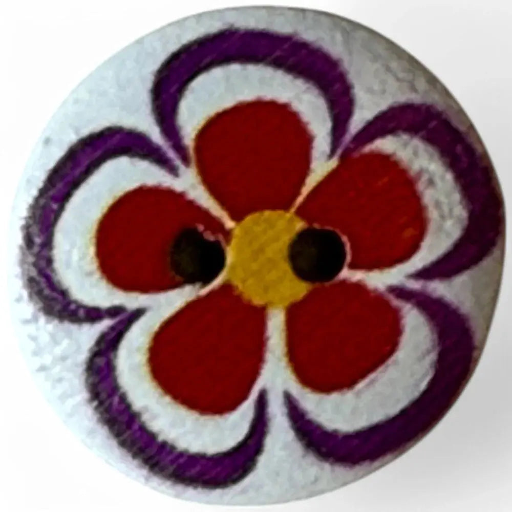 Round button with flower design.