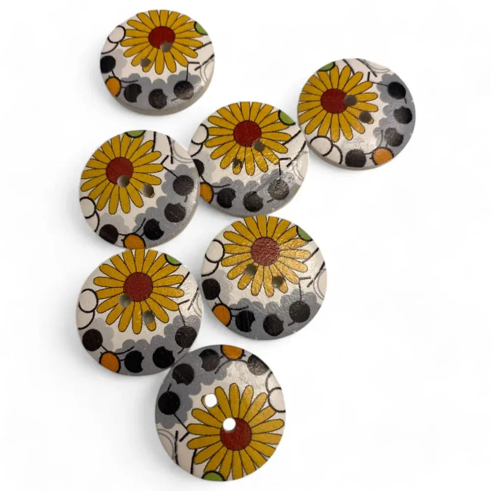 Seven floral-patterned wooden buttons.