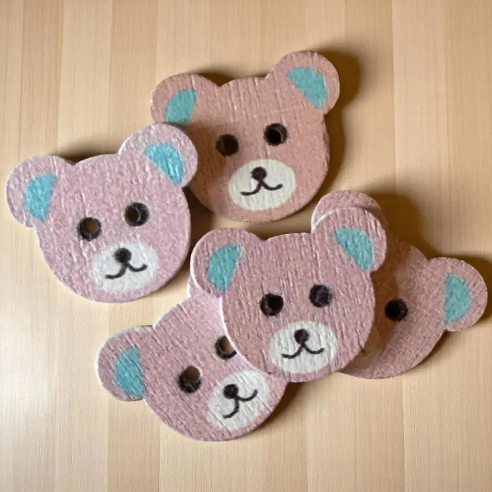 Pink wooden teddy bear coasters.