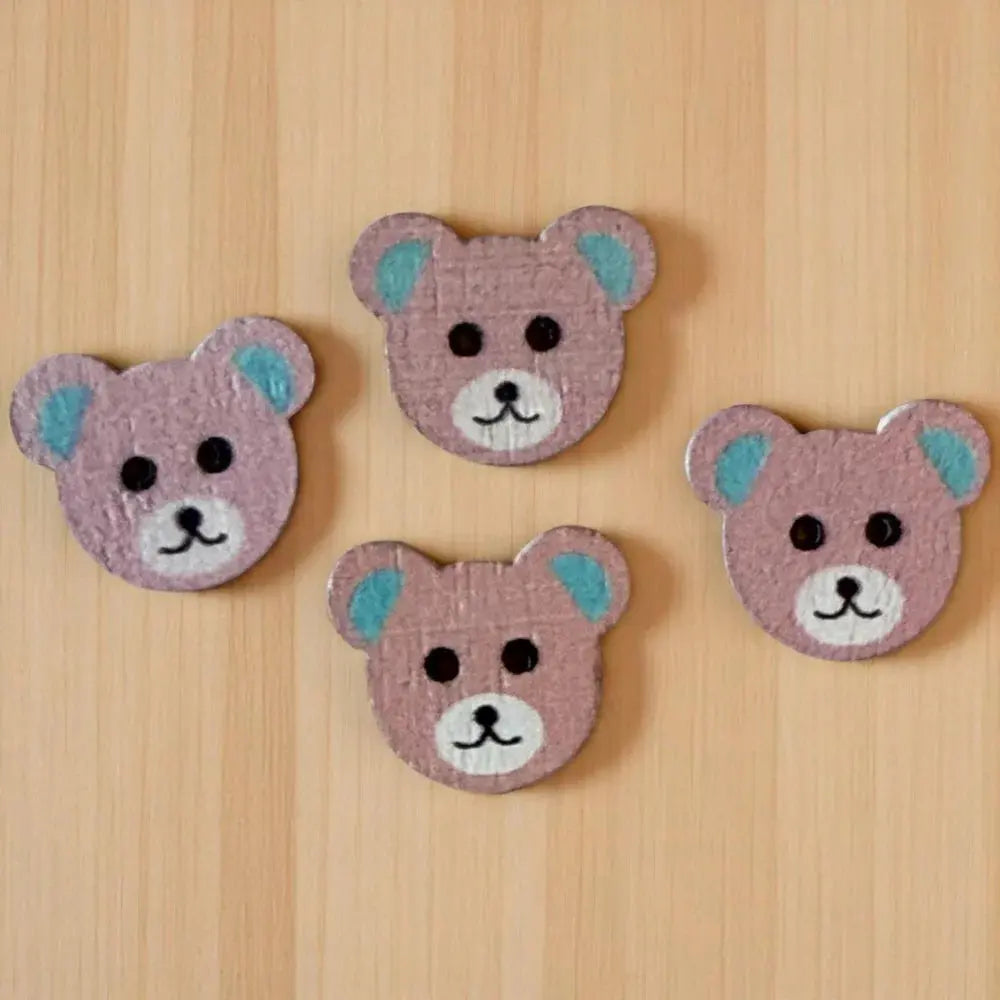 Four pink teddy bear buttons.