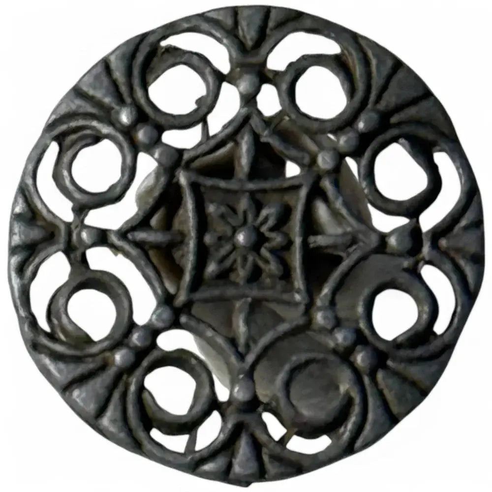 Ornate circular metal brooch.