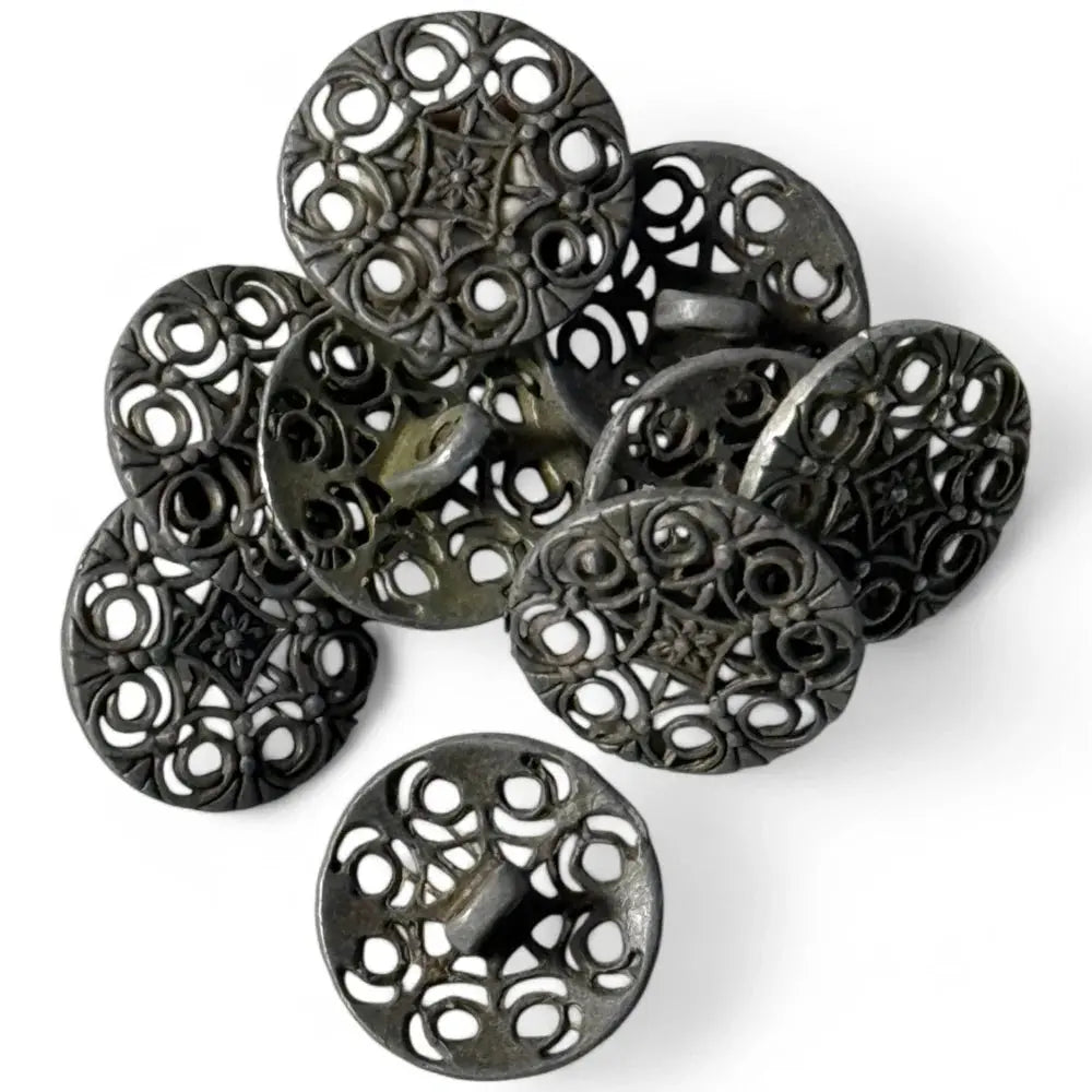Pile of ornate metal buttons.